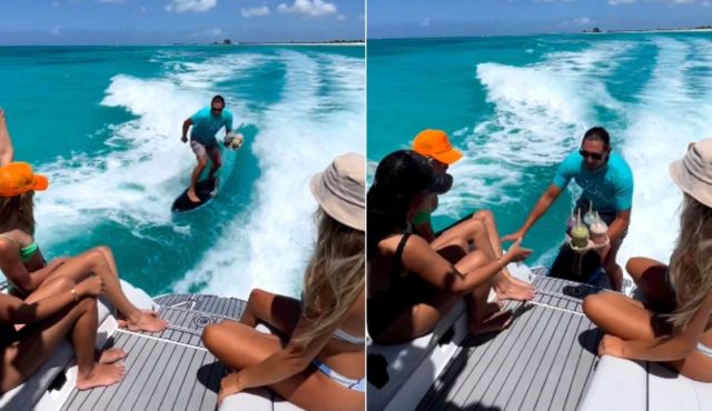 Ένα πρωτότυπο delivery... στα κύματα - Άντρας μεταφέρει ποτά στη θάλασσα κάνοντας σερφ